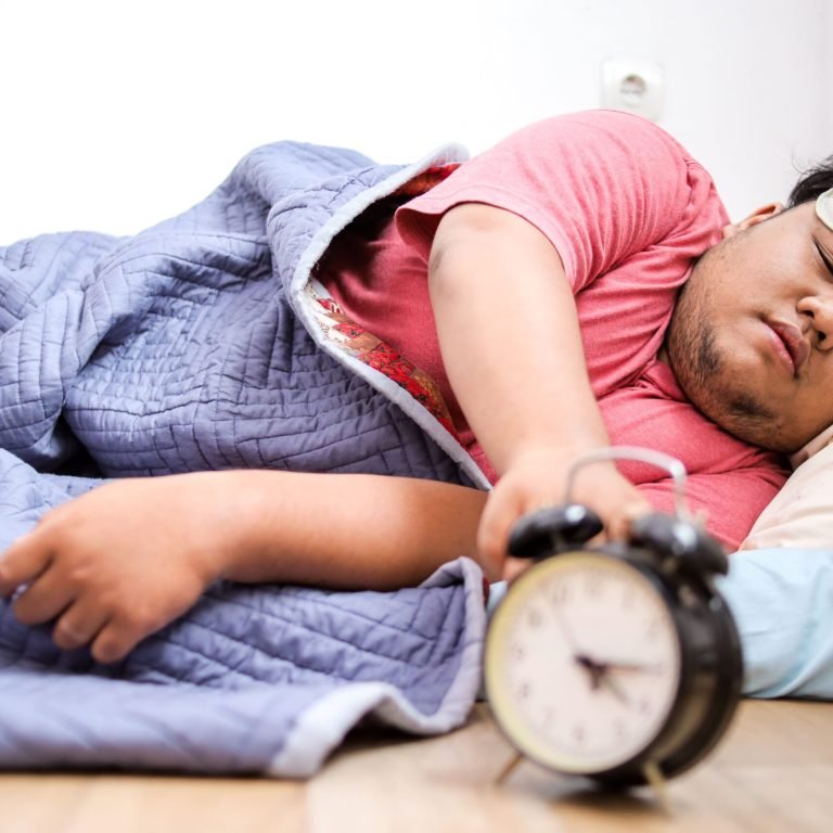 man-sleeping-in-bed-reaching-for-alarm-clock-2026-03-25-06-29-51-utc (1)