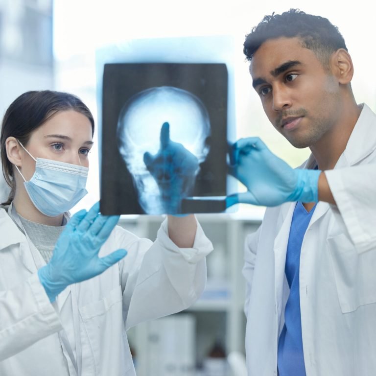 Picking up on any irregularities. Shot of two doctors analysing an x-ray together in a hospital